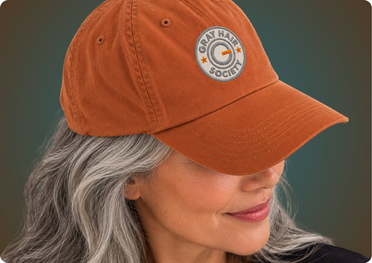 MULHER GRISALHA COM BONÉ COM DESIGN EXCLUSIVO DA COLEÇÃO GRAY HAIR SOCIETY DA MARCA ORGULHO GRAY